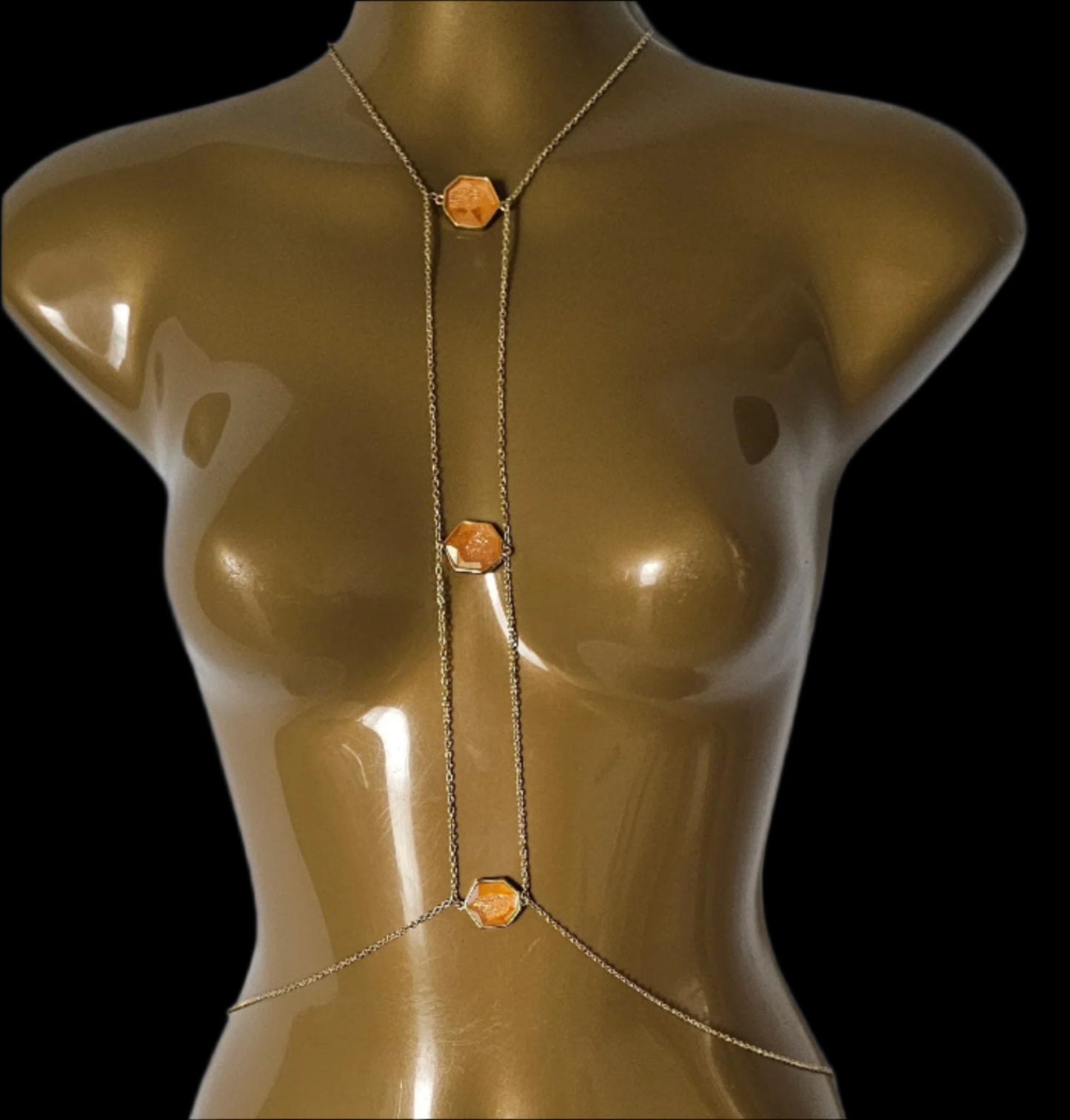 Gold-colored mannequin torso on a white background