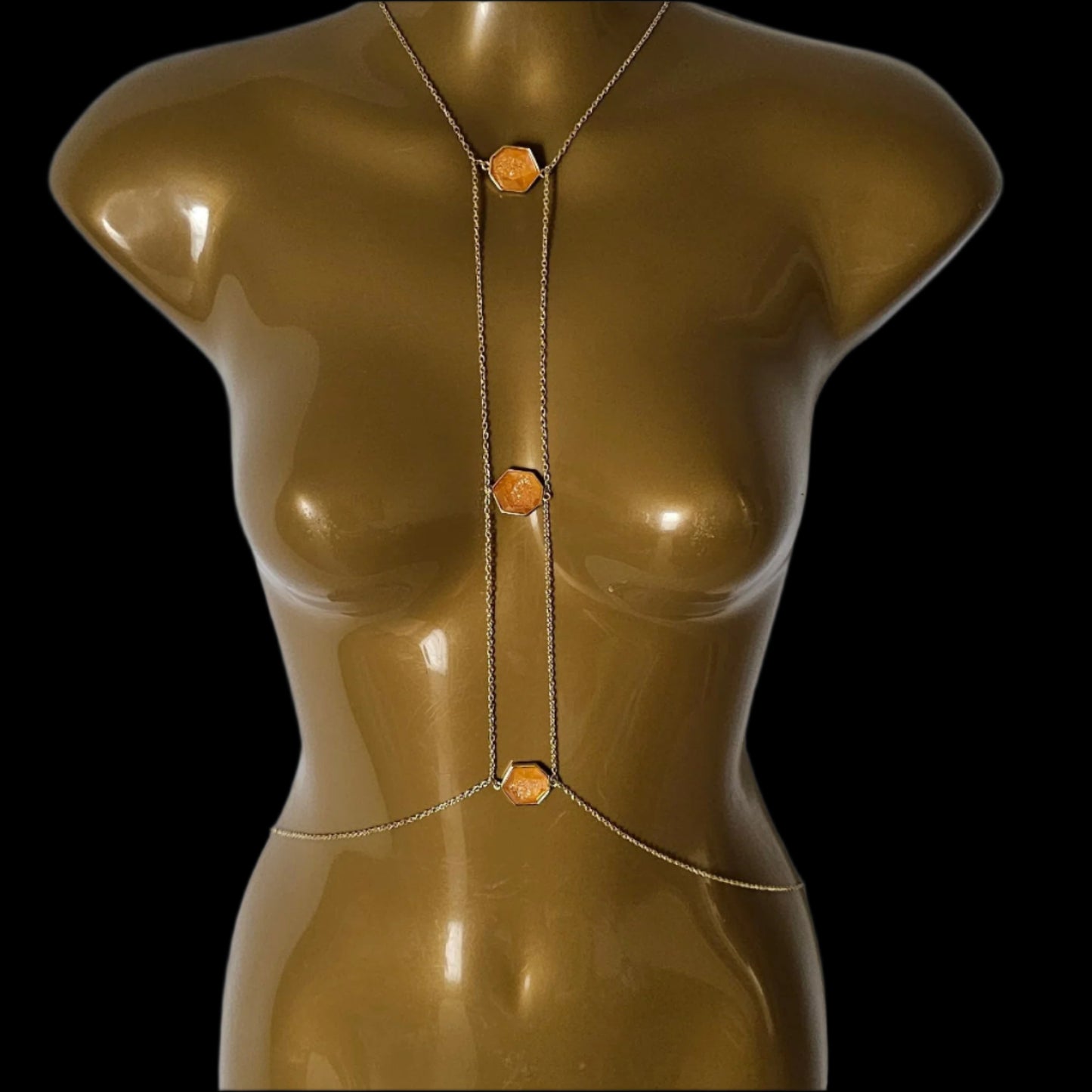 Bronze-colored mannequin torso on a white background